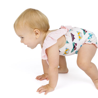 Baby in a diaper with a colorful butterfly pattern on a white background