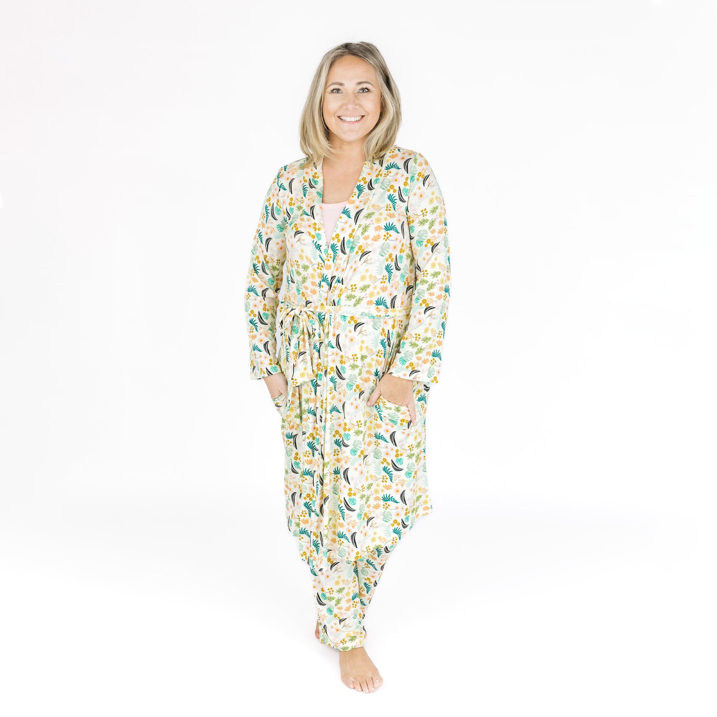 Woman wearing the Tropical Blooms bamboo robe, highlighting the soft ribbed texture and relaxed fit.
