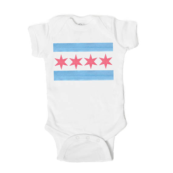 White baby bodysuit with a blue stripe and pink stars on a white background
