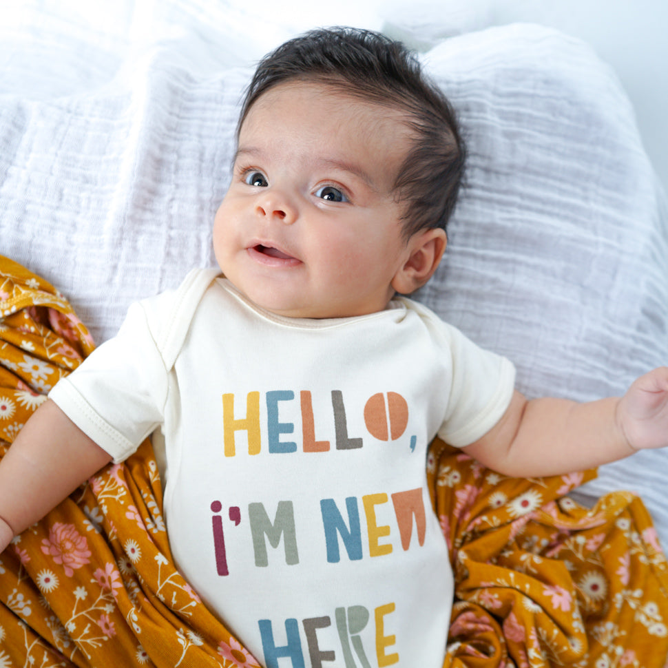 Baby wearing Im New her cotton bodysuit